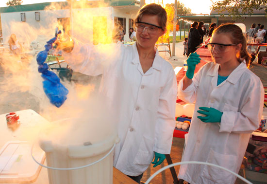 two students conducting an experient at the STEAM Carnival